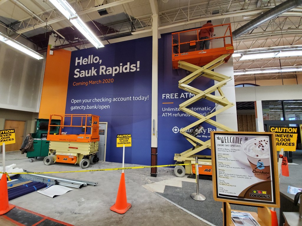 Large temporary mural wall covering construction area installed by Next Signs in Fargo ND