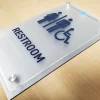 ADA Signs / Wayfinding 5 ADA compliant restroom sign with a frosted acrylic panel, dark blue raised tactile lettering, male female and wheelchair accessibility icons, Braille, and brushed metal standoff hardware