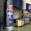 Pepsi-branded column wraps installed on structural pillars throughout the Fargodome concourse, featuring full-coverage vinyl graphics that transform support columns into branded touchpoints