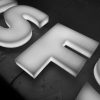 Dimensional Letters 4 Close-up detail of large white illuminated acrylic dimensional letters against a dark background, showing the depth and surface quality of custom backlit letter signage